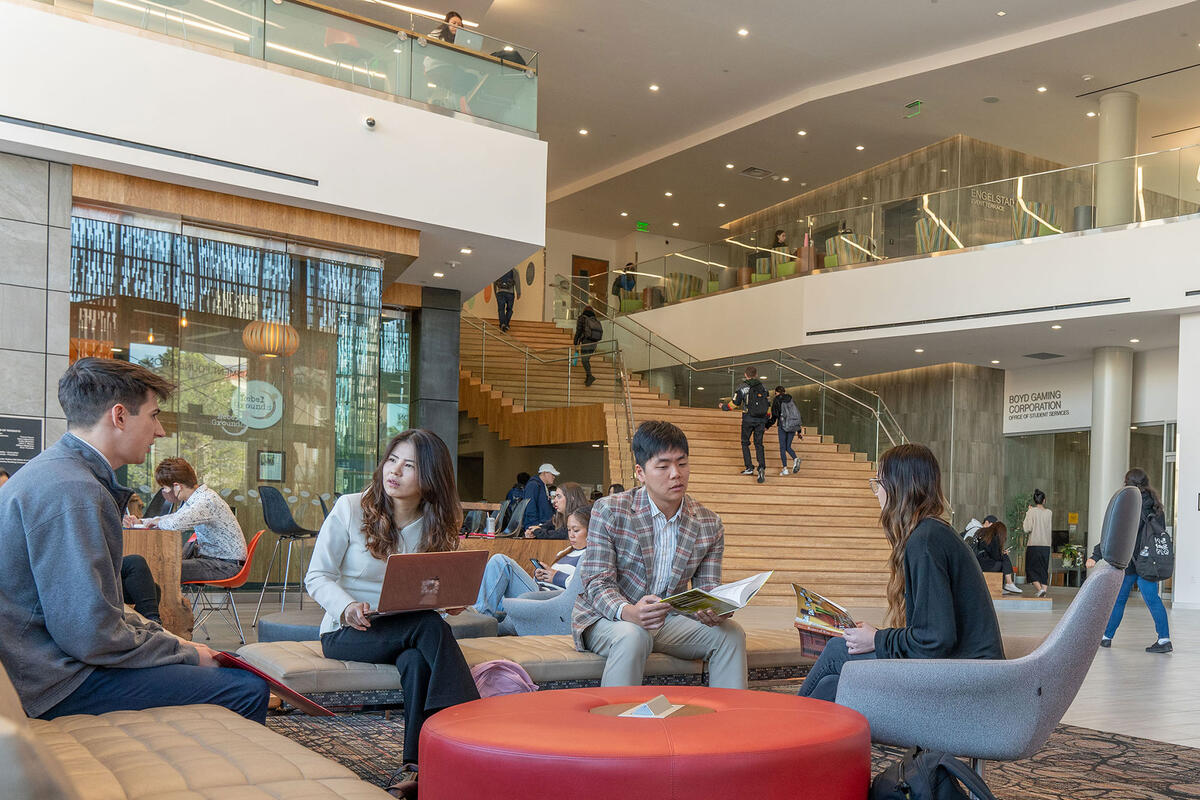 A group of people chatting in the main area of a building